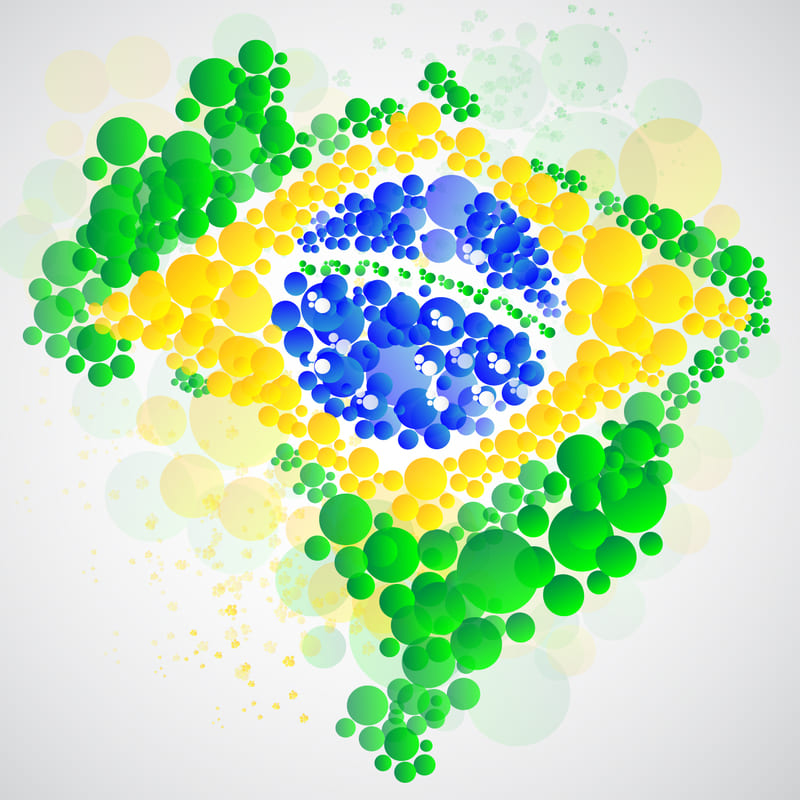Um mapa do Brasil feito de imagens de bolinhas, formando o contorno do mapa, mas com as bolinhas nas cores da bandeira brasileira.